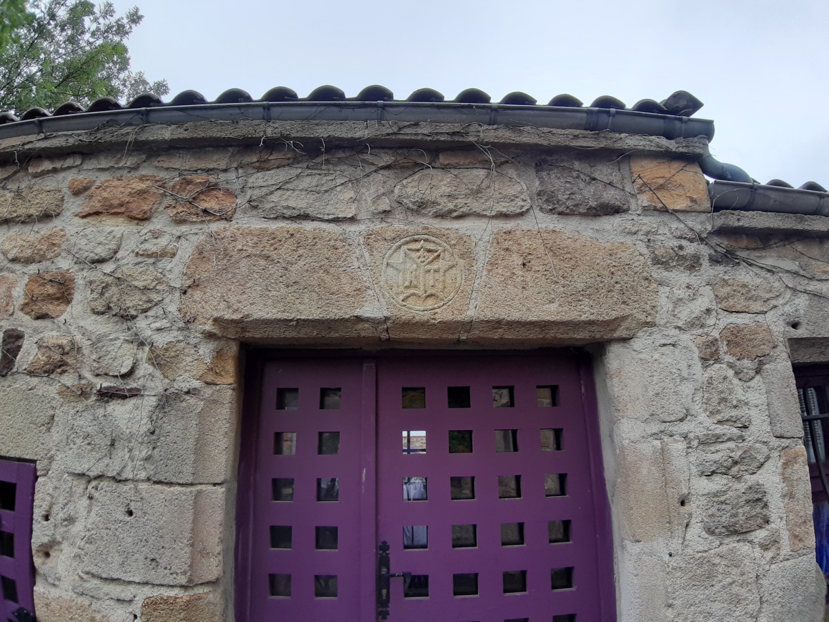 Blason de Montpeyroux (63) au-dessus d'une porte violette